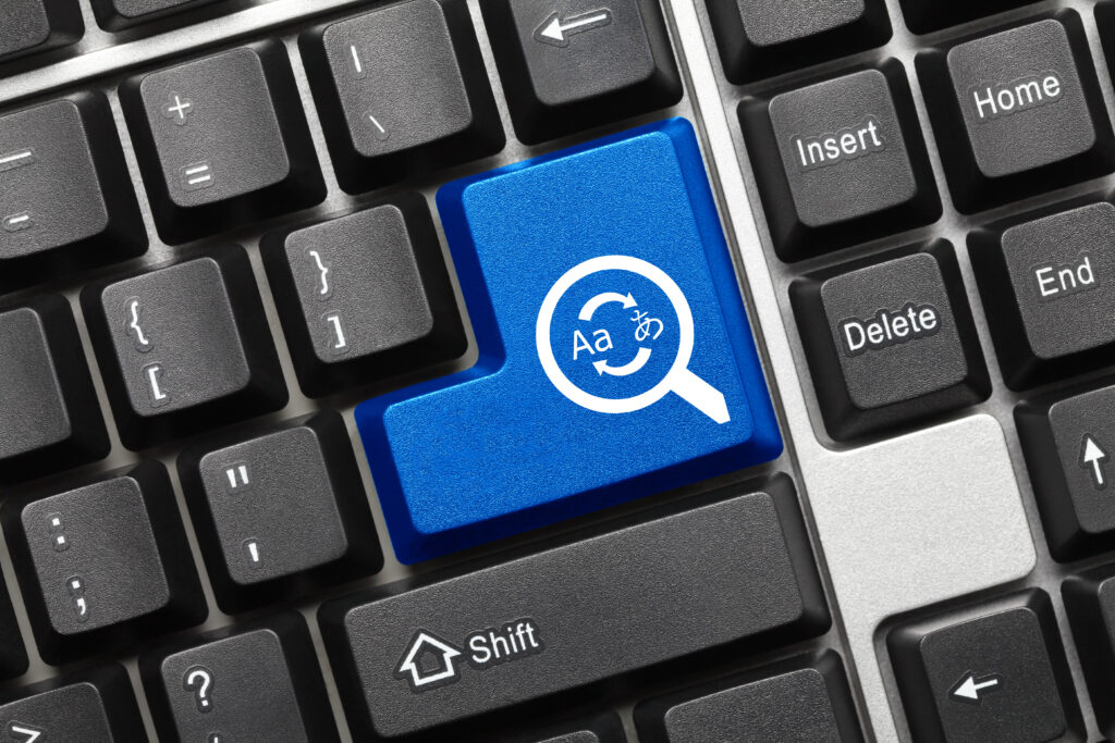 A close-up view of a keyboard with a blue key highlighted with the word "Search" printed on it. The rest of the keyboard is out of focus in the background.